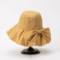 Detail of yellow sun hat with large bow and vertical texture on a wooden stand - M(56-58cm) / Yellow