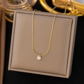 Close-up of golden necklace with a teardrop crystal pendant on a grey jewelry display box - Bead Chain Water Drop / Gold