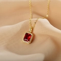 Elegant gold titanium necklace featuring a rectangular red gemstone pendant on beige silk - Red