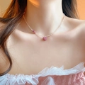 Detail of a pink heart pendant on a delicate beaded choker necklace worn by a model - White Pink Heart Beaded (20#)