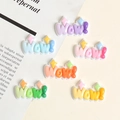 Macro shot of colorful resin WOW letters in candy tones for DIY charms and shoe decor - Wow Pop Art