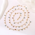 Detail view of a long gold chain necklace with colorful bohemian enamel bead charms - Colorful Bohemian Bead Chain