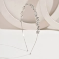 Detail view of silver metal headband with rhinestone flowers and leaf decorations - White Zirconia Silver