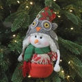 Christmas snowman plush pendant with owl knit hat hanging on a festive lighted tree - Snowman with Green Scarf