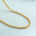 Golden necklace featuring unique circular links with radial texture on a blue background - O-shape Textured Chain