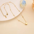 Macro shot of 316L stainless steel heart necklace with bead chain and lobster clasp closure - Gold Heart Necklace
