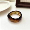 Wide resin bangle featuring a brown and amber marble textured finish in a circular design - Amber