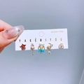 Set of 5 gold-plated earrings with colorful zircon shapes for women on a blue backdrop - Star Moon Wand Style (0901)