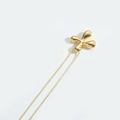 Minimalist golden balloon pendant necklace with polished finish on a white background - Letter X