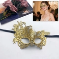 Elegant gold lace masquerade mask with intricate cutout patterns and black satin ribbons - Phoenix