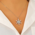 Sparkling silver snowflake necklace with inlaid diamonds and pearls worn by model - 18 White K Style (X057 Necklace)