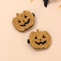 Dettaglio di fermagli per capelli a zucca glitterati dorati con facce nere per Halloween - Zucca glitterata oro / Fermaglio per capelli a forma di zucca traforata oro