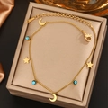 Detailed macro of 18K gold plated anklet with blue beads and star-moon pendants - Gold Star and Moon Anklet