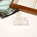 Close-up of a square pearlescent white hair claw clip displayed on a wooden tray - 5cm Square / PVC 5cm Square - Iridescent Beige