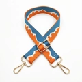 Detail of adjustable blue and orange jacquard bag strap with gold metal hooks and buckles - Sea Blue Orange