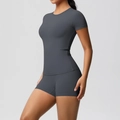 Side view of woman in dark gray high-stretch compression top and high-waist yoga shorts - S / Top And Bottom / Graphite Grey