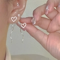 Elegant silver heart tassel earrings featuring an S-shaped design on a fashion model - Silver Heart Matte S-Shaped Tassel Earrings (2369)