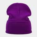 Close-up of the high-elastic ribbed knit texture on a purple winter beanie hat - Deep purple