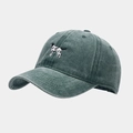 Detailed close-up of embroidered hound dog logo on washed dark green cotton baseball cap - Green