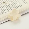 Minimalist matte cream white flower hair claw clip displayed on an open vintage book page - 4*3.5*3.6 / White