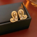 Macro shot of gold-plated heart earrings with rope texture edges and cubic zirconia - Gold (Silver Earring Post)