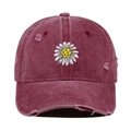 Close-up of distressed wine red baseball cap with daisy embroidery and vintage fraying - One Size / Burgundy