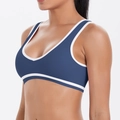 Detail of the high-stretch sports bra with white contrast piping on navy blue fabric - S / Navy Blue