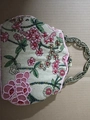 Macro shot of pink and green floral beadwork on a vintage linen handbag with metal handle - Floral Pink