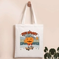 Detail of white canvas tote bag with Stay Spooky pumpkin skater print and soft texture - Skateboarding Pumpkin Man