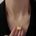 Elegant gold U-shape pendant necklace with white pearl on a woman's neck - U-Shaped Pearl Necklace / Gold (8821)