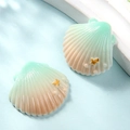 Detailed view of pink and green gradient resin shells with gold star accents for DIY crafts - Small / Green + Champagne