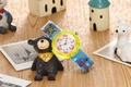 Macro detail of kids waterproof watch showing colorful dial and cartoon strap on stand - Construction Worker