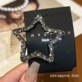 Detail of a 5cm silver star hair clip with rhinestones on a black display card - Approx. 5cm / Grey Rhinestone Star