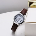 Macro detail of the vintage quartz watch with Roman numerals and dark brown leather strap - Silver Case Roman Numerals White Dial Coffee Strap