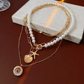 Layered gold starfish and shell necklace with white pearls for a beach vacation look - Starfish Conch Shell Layered Multi-Layer Necklace