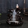 Deep brown ceramic backflow incense burner in mountain shape with cascading white smoke - High Mountain Flowing Water