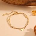Doppelreihiges goldenes Edelstahl-Herzarmband mit weißem Zirkon und strukturierten Anhängern - Gold