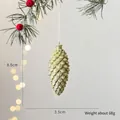Golden glitter pine cone ornament with red berries and size markings 8.5cm by 3.5cm - Gold Pinecone