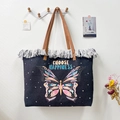 Detailed view of the vibrant butterfly print and slogan on this large canvas tote bag with fringe - Text Butterfly Print / 50x35x12cm