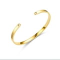 Detail view of a gold C-shaped titanium steel bracelet with heart cutouts at the ends. - Heart Hole / 4mm / Gold