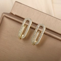 Detailed close-up of 14K gold geometric earrings with zircon stones on a jewelry box - Paperclip Geometric (076)