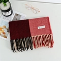 Detail of red and coral cashmere scarf showing fine twill weave and elegant fringe edges - Red
