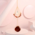 Detailed view of natural red agate moon sun catcher with colorful crystals and gold chain - Agate