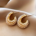 Elegant gold C-shaped hoop earrings with faux pearl embellishments on silk background - C-Shaped Pearl Stud Earrings