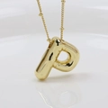Macro view of gold-plated chunky bubble letter P pendant with high-shine metallic finish - Letter P (Necklace)