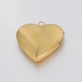 Detailed close-up of a polished gold heart-shaped locket pendant on a white background - Gold