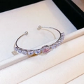 Elegant silver open bangle featuring a pink oval zircon stone and halo setting crystals - Style 27 / Silver