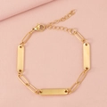 Close-up of three gold-tone rectangular metal plates on a paperclip chain bracelet - 3 Bars / Gold