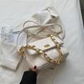 Elegant cream quilted crossbody bag with golden twist lock and chain strap on white blazer - White
