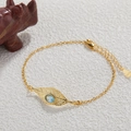 Gold leaf bracelet with blue gemstone on white textured background in S925 silver - Bracelet / Gold / Topaz